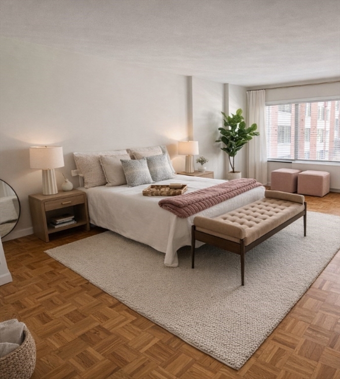 22 Chestnut Place, Unit 210 Brookline, MA 02445 - Photo 2 of 16 a bedroom with a bed and a couch