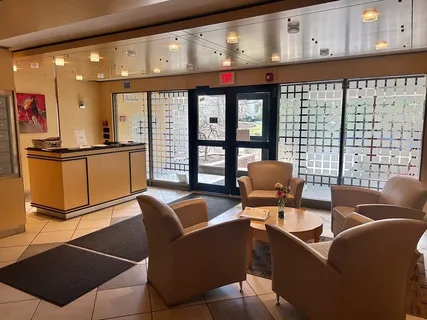 a living room with furniture a floor to ceiling window and a flat screen tv