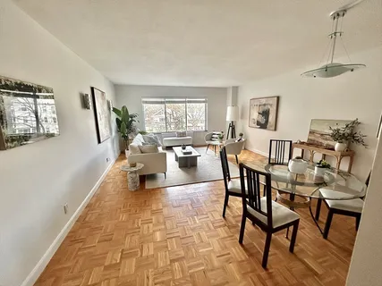 a living room with lots of furniture and a wooden floor