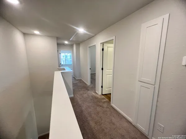 a view of a hallway with closet and wooden floor