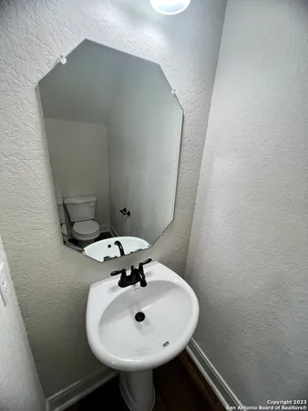 a bathroom with a sink and mirror
