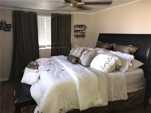 a bedroom with a bed and window