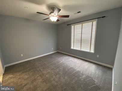 621 Cobblestone Boulevard, Unit T3 Fredericksburg, VA 22401 - Photo 20 of 34 an empty room with windows and fan