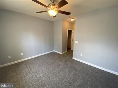 621 Cobblestone Boulevard, Unit T3 Fredericksburg, VA 22401 - Photo 27 of 34 an empty room with closet and a ceiling fan
