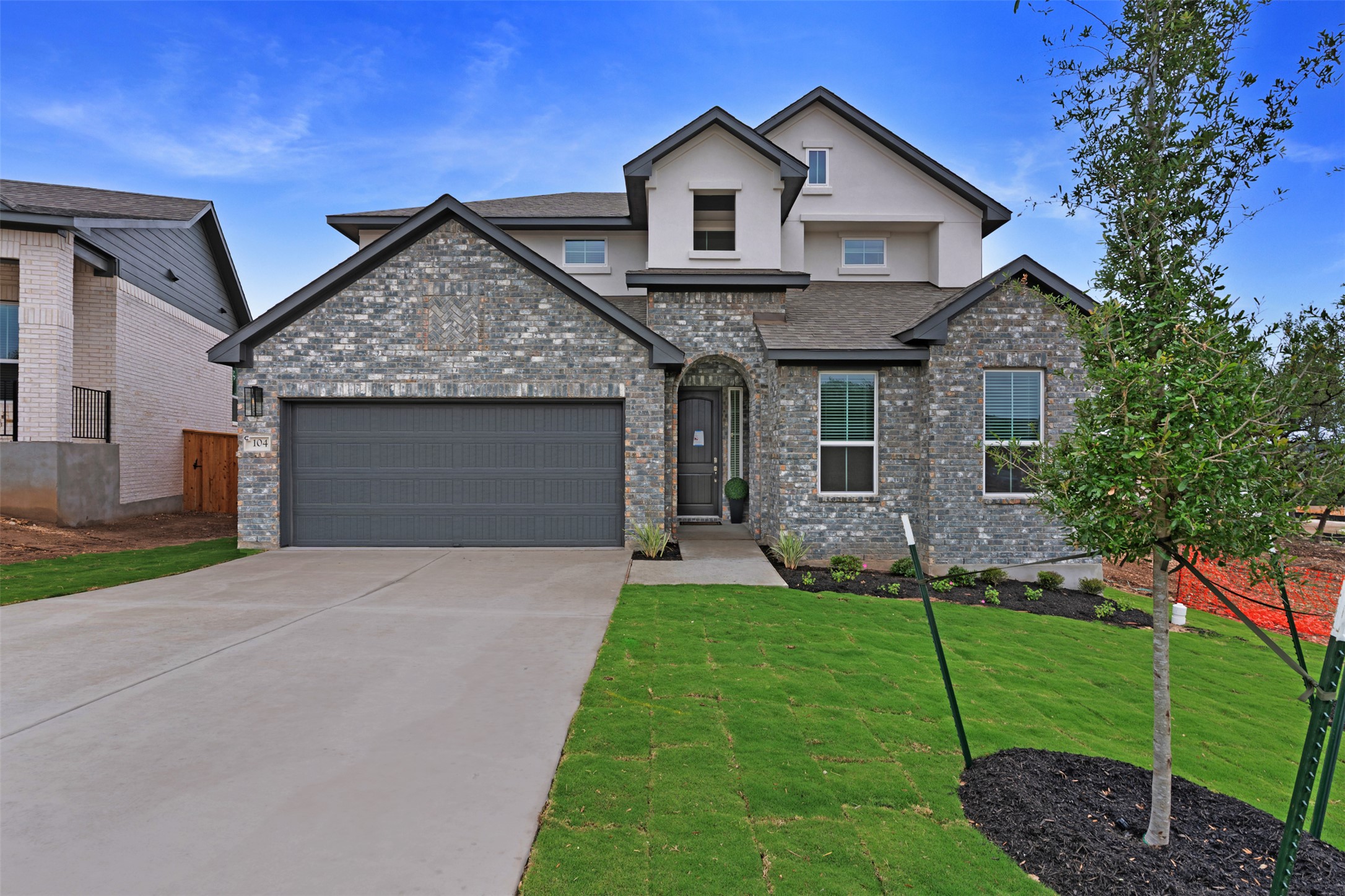 a front view of a house with a yard and garage