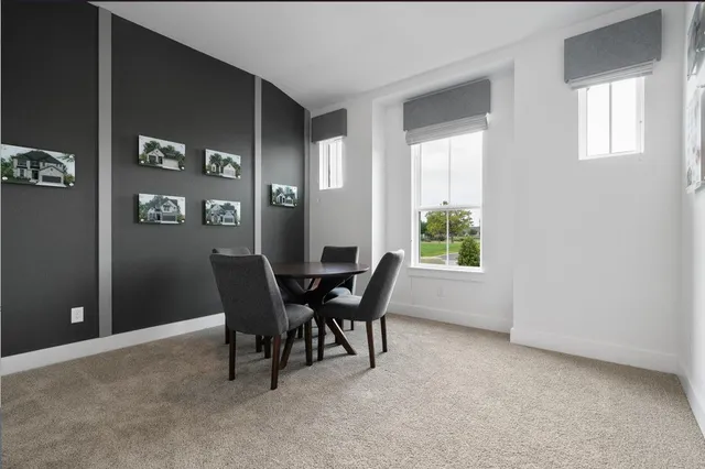 a view of a dining room with furniture and window