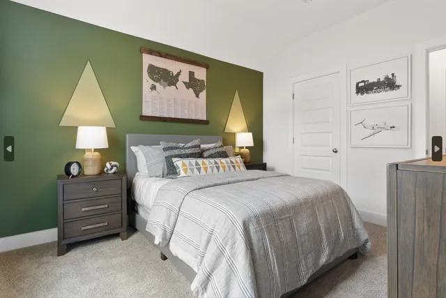 a bedroom with a bed and a painting on the wall