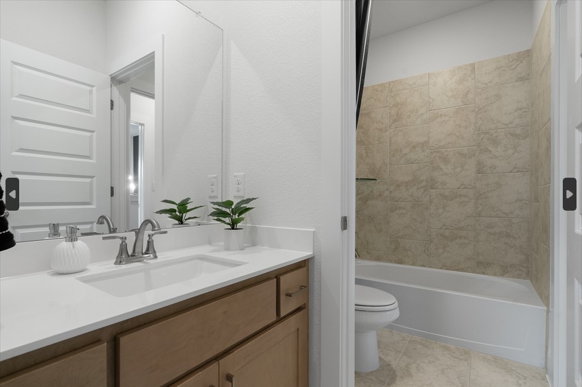 104 Beautiful Wisdom Court Georgetown, TX 78628 - Photo 19 of 29 a bathroom with a granite countertop sink a toilet and bathtub