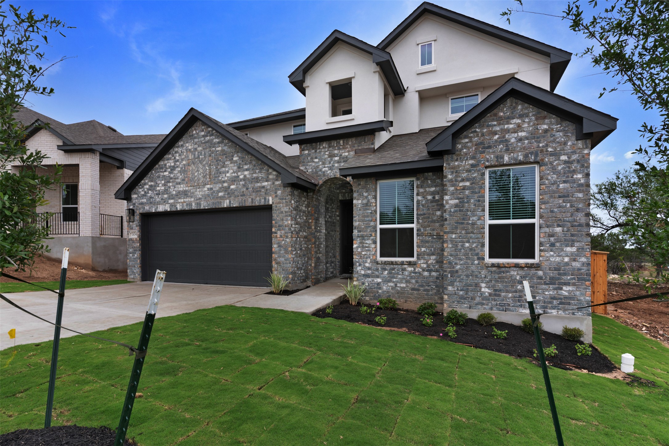 104 Beautiful Wisdom Court Georgetown, TX 78628 - Photo 2 of 33 a front view of a house with a garden and plants