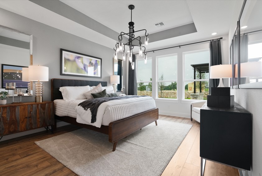 104 Beautiful Wisdom Court Georgetown, TX 78628 - Photo 10 of 29 a spacious bedroom with a bed and wooden floor