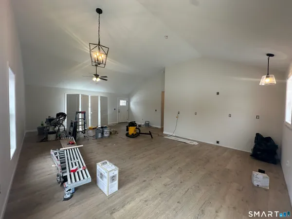 a living room with furniture and a chandelier
