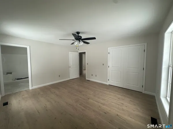 en empty room with windows and entrance