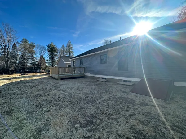 a view of a house with a backyard