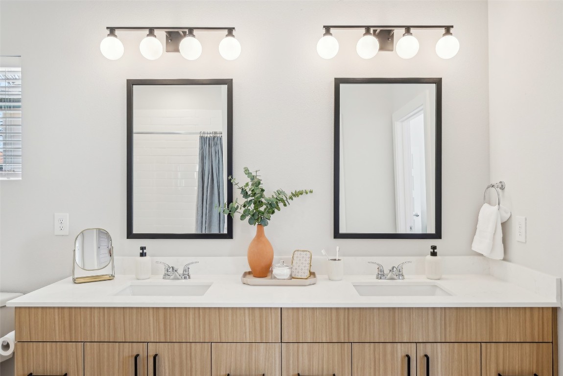 3651-324 South Custer Road McKinney, TX 75070 - Photo 22 of 28 a bathroom with double vanity sinks a vanity and a mirror