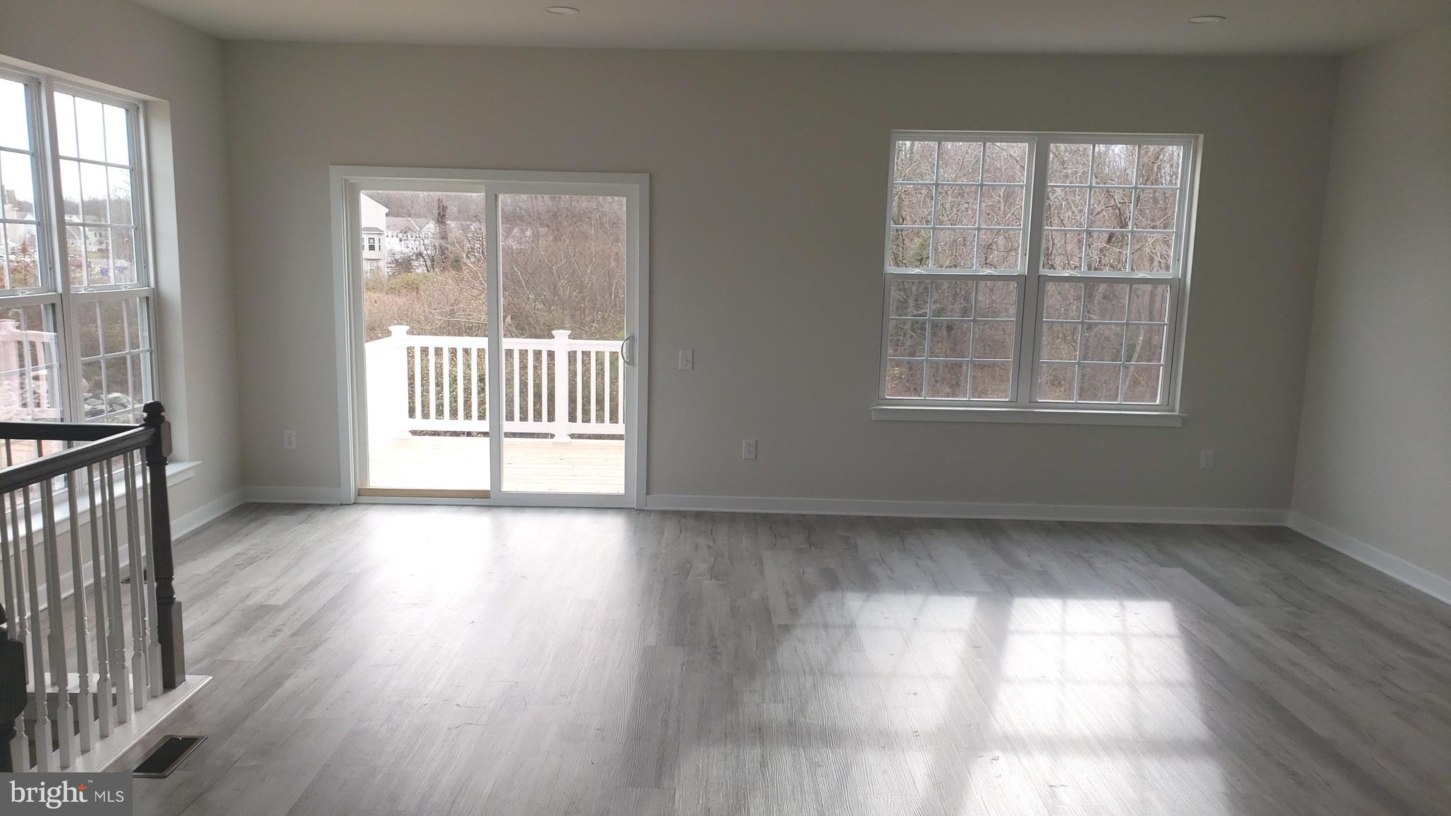 214 Case Road Townsend, DE 19734 - Photo 2 of 18 an empty room with wooden floor and windows