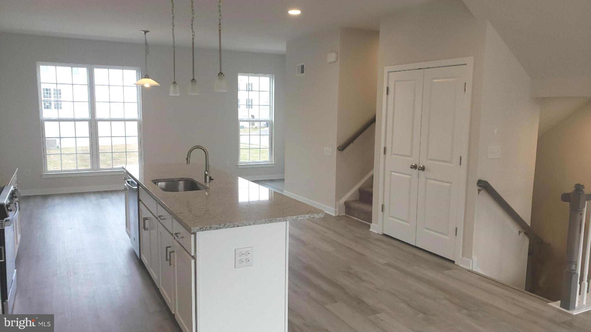 214 Case Road Townsend, DE 19734 - Photo 4 of 18 a kitchen with granite countertop a sink and a wooden floor