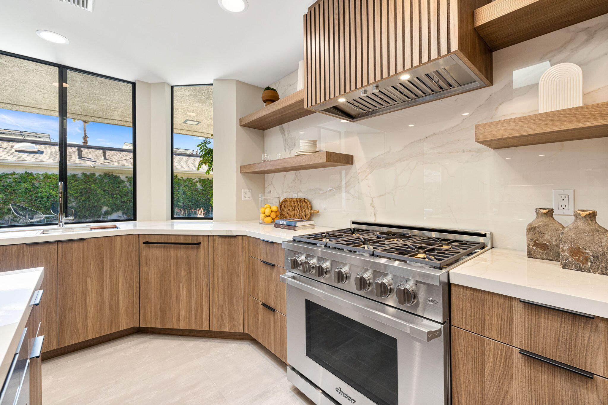 27 Colgate Drive Rancho Mirage, CA 92270 - Photo 28 of 87 a kitchen with stainless steel appliances granite countertop a stove and a sink