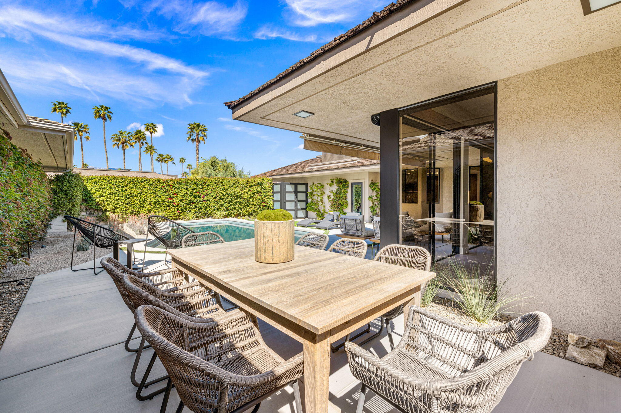 27 Colgate Drive Rancho Mirage, CA 92270 - Photo 56 of 87 a view of a patio with table and chairs and potted plants