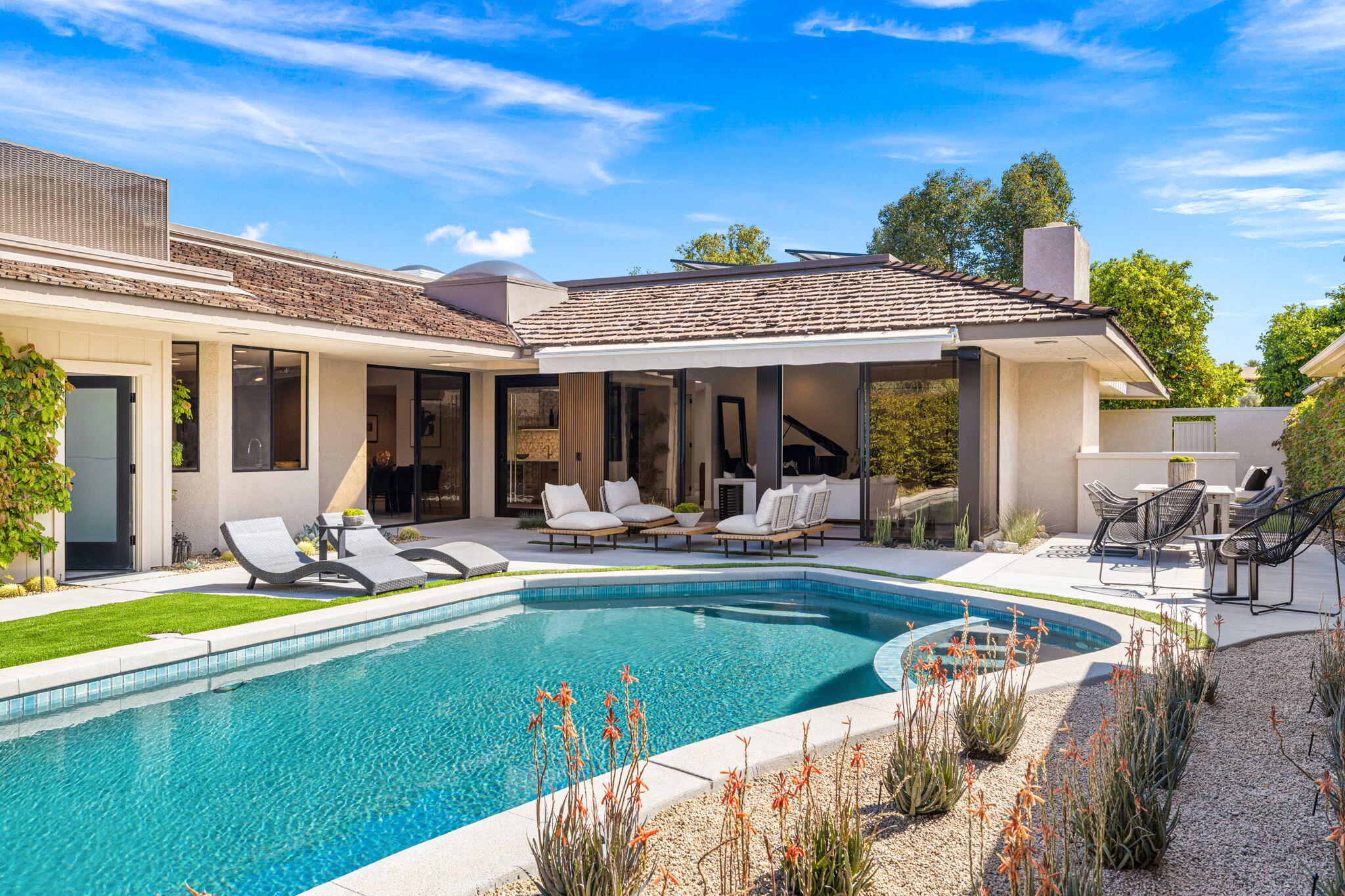 27 Colgate Drive Rancho Mirage, CA 92270 - Photo 10 of 87 a view of a patio with couches chairs and swimming pool table and chairs