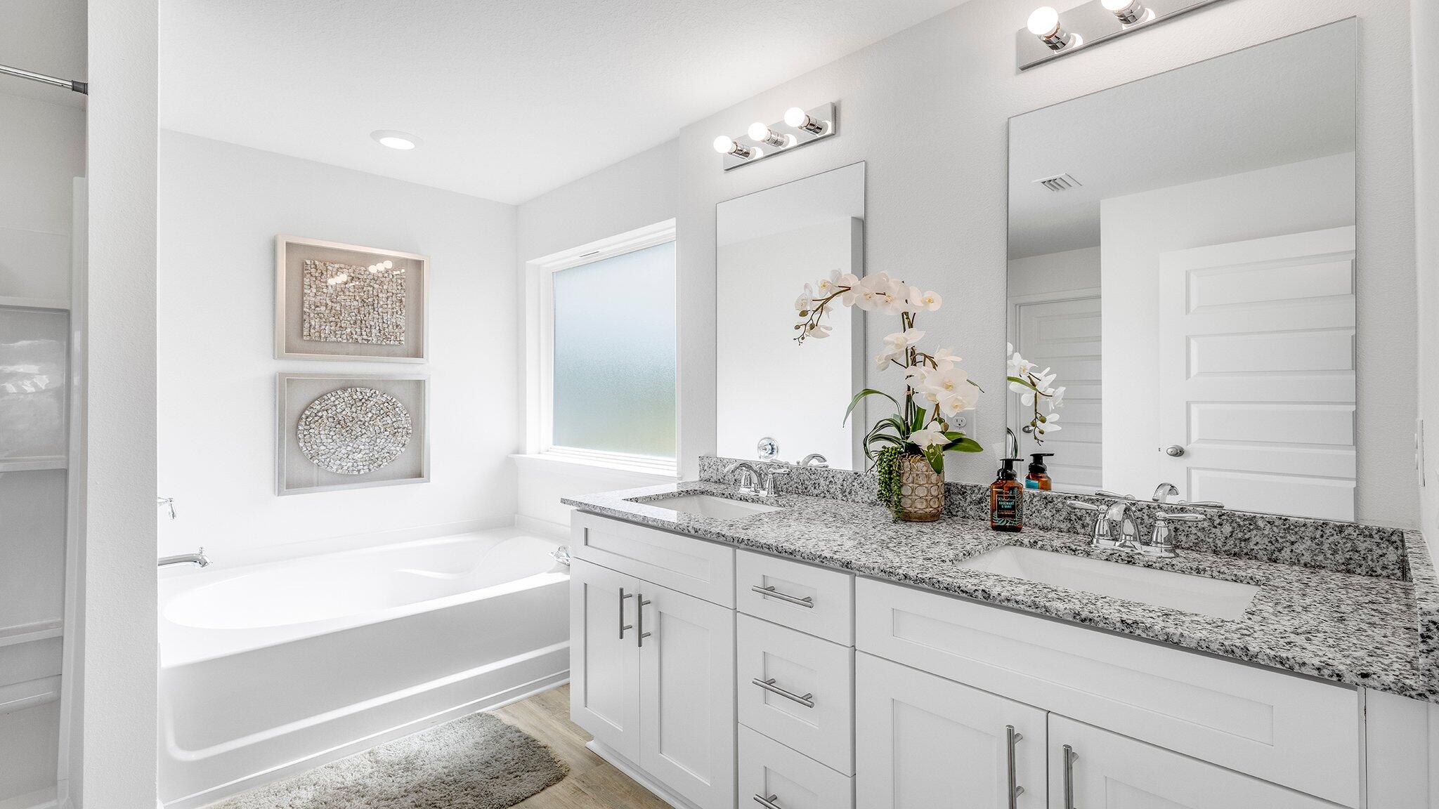 20 Bluebeech Street Freeport, FL 32439 - Photo 16 of 26 a bathroom with a tub sink and mirror