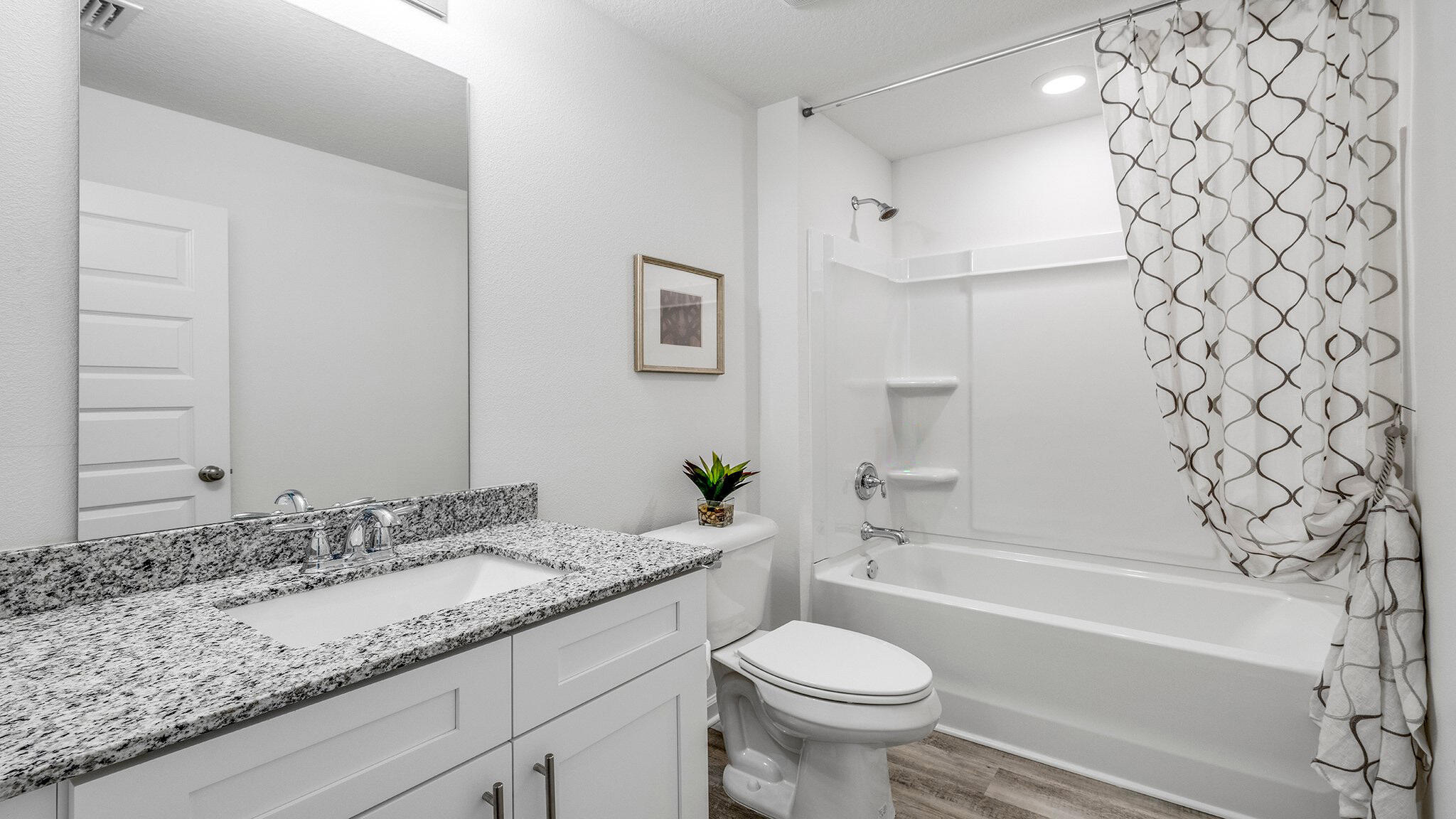 20 Bluebeech Street Freeport, FL 32439 - Photo 22 of 26 a bathroom with a granite countertop sink and a mirror a toilet