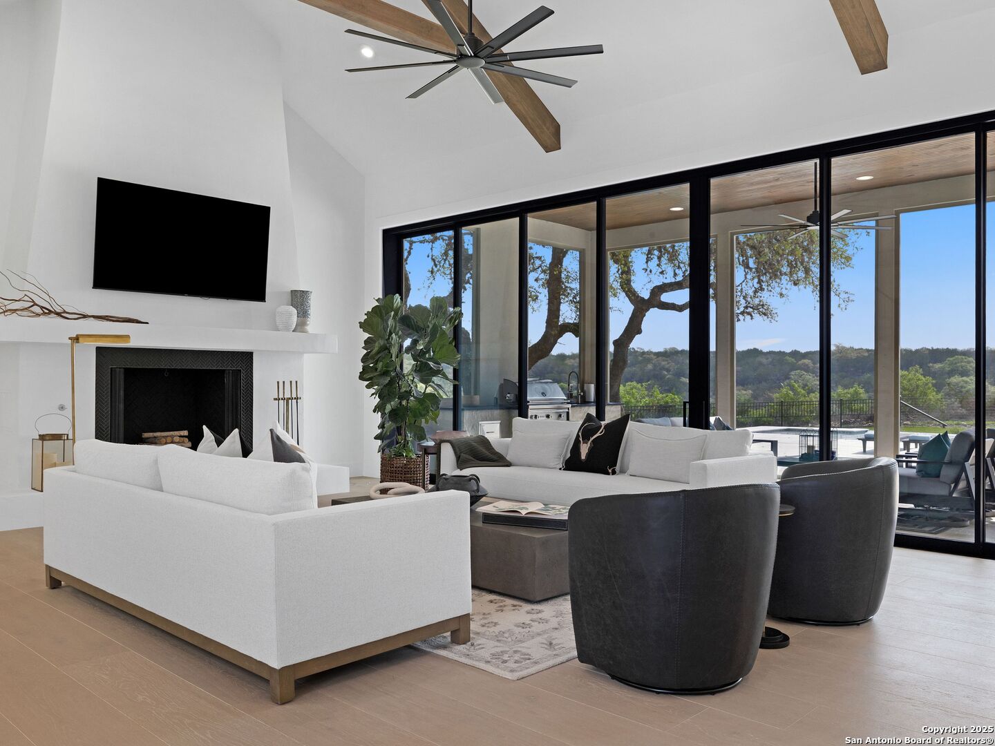 137 Phillip Ranch Road Boerne, TX 78006 - Photo 11 of 61 a living room with fireplace furniture and a flat screen tv