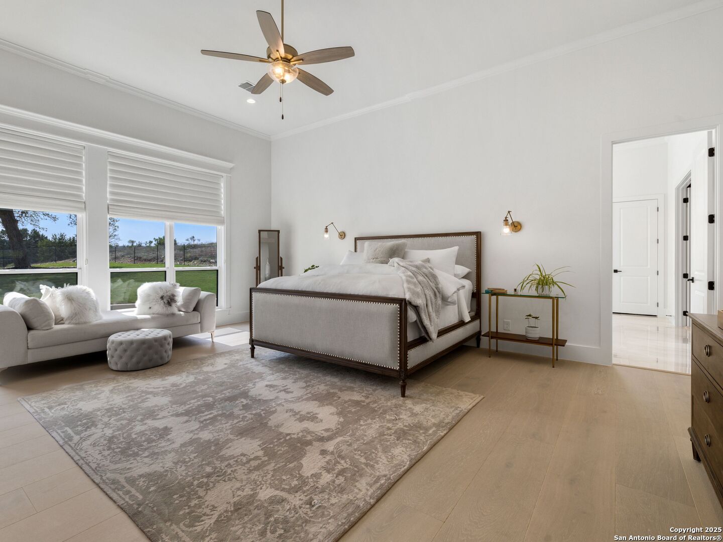 137 Phillip Ranch Road Boerne, TX 78006 - Photo 22 of 61 a spacious bedroom with a bed and a couch