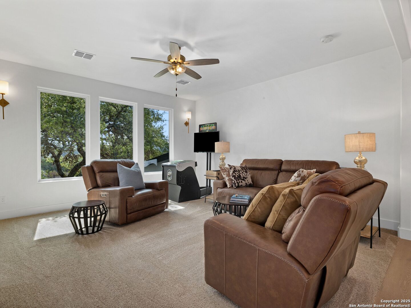 137 Phillip Ranch Road Boerne, TX 78006 - Photo 37 of 61 a living room with furniture and a flat screen tv