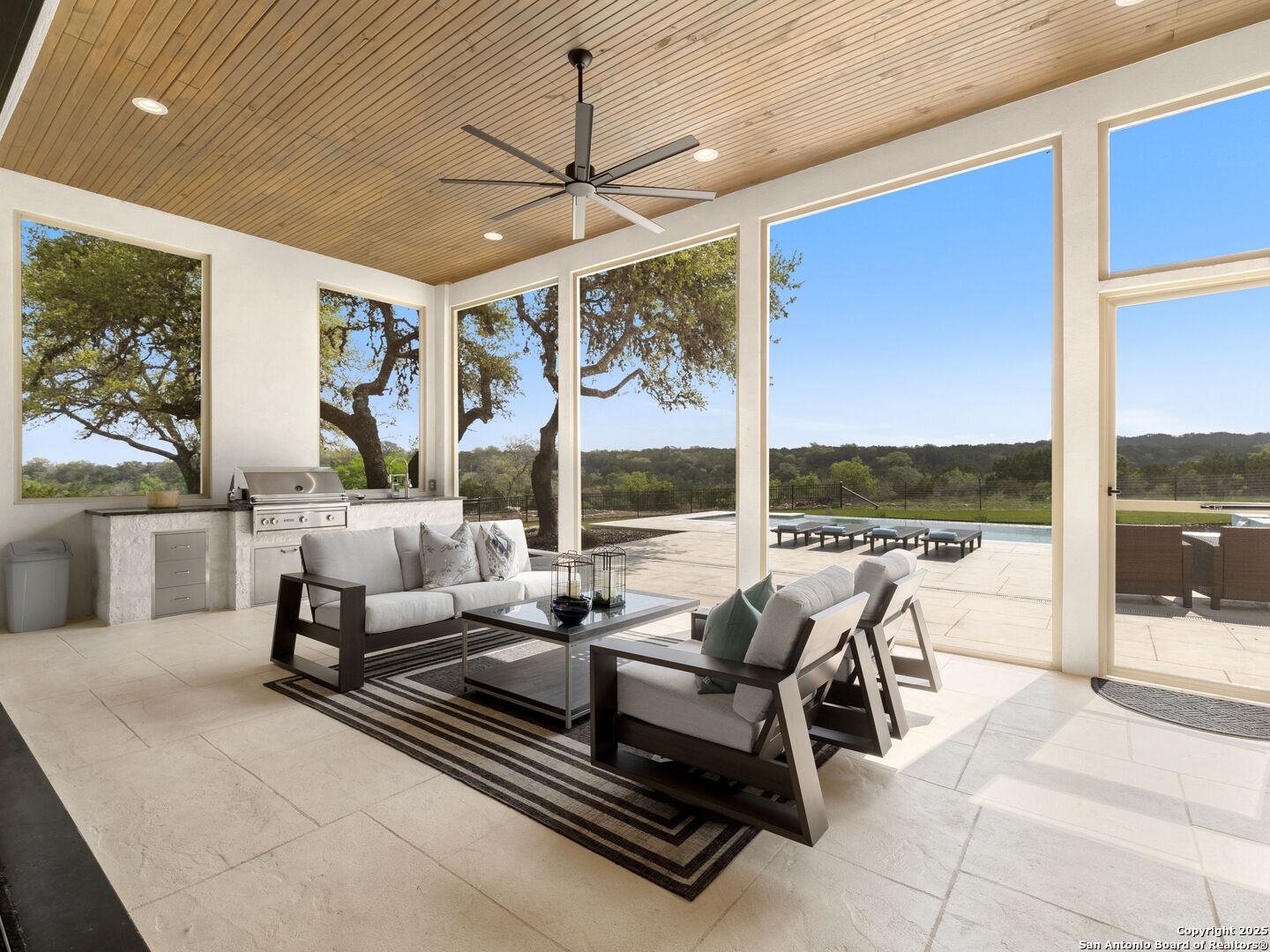 137 Phillip Ranch Road Boerne, TX 78006 - Photo 43 of 61 a living room with patio furniture and a floor to ceiling window
