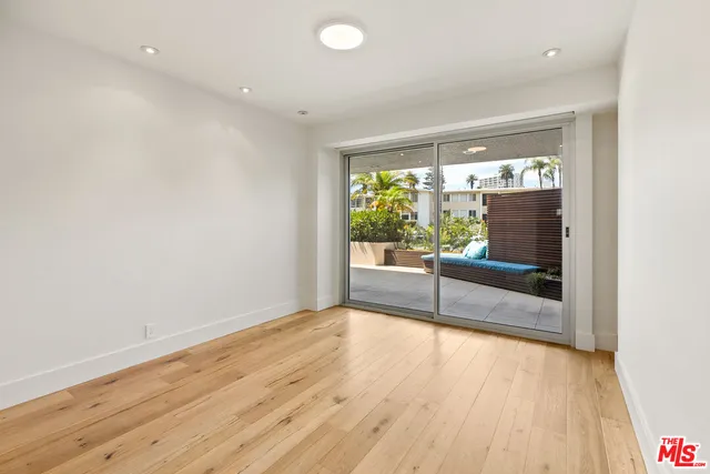 a view of a room with wooden floor and outdoor space