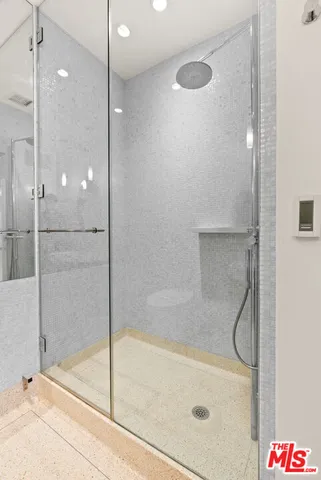 a bathroom with a shower and a shower