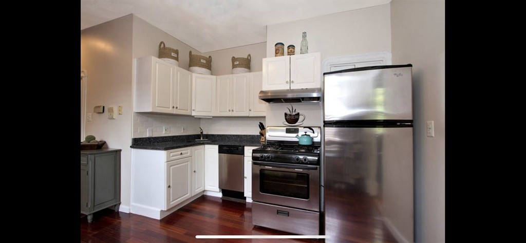 25 Sullivan Street, Unit 3 Boston, MA 02129 - Photo 3 of 13 a kitchen with stainless steel appliances and wooden floor