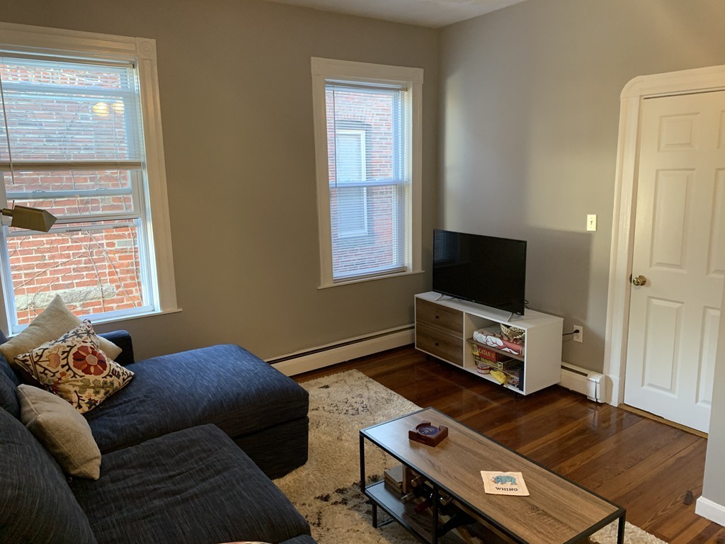 25 Sullivan Street, Unit 3 Boston, MA 02129 - Photo 7 of 13 a living room with furniture and a flat screen tv