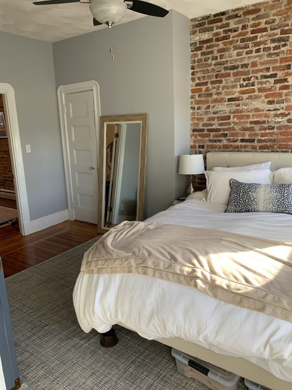 25 Sullivan Street, Unit 3 Boston, MA 02129 - Photo 8 of 13 a bedroom with a bed and wooden floor