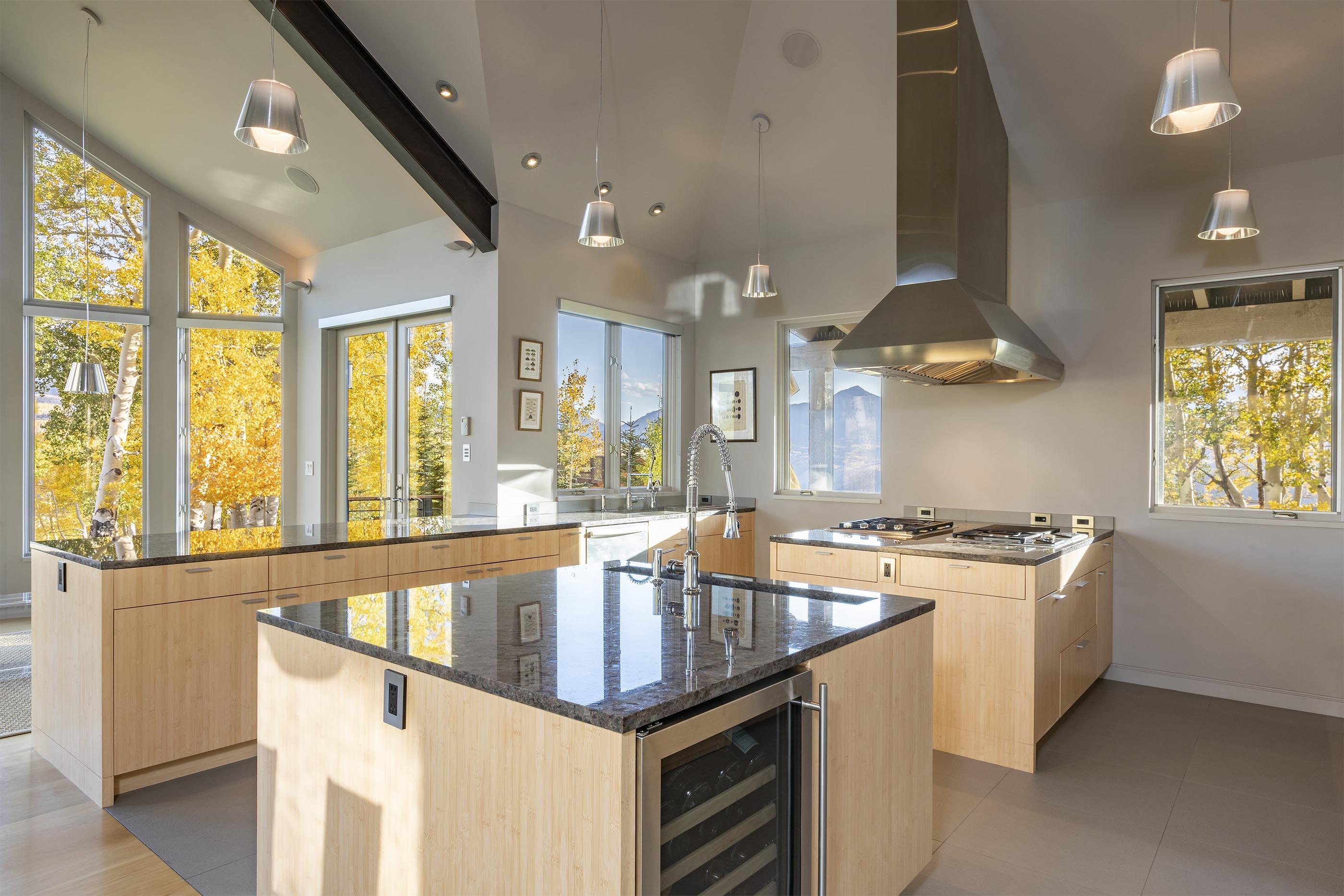 107 Miguel Road Telluride, CO 81435 - Photo 14 of 32 a kitchen with granite countertop a stove and a sink