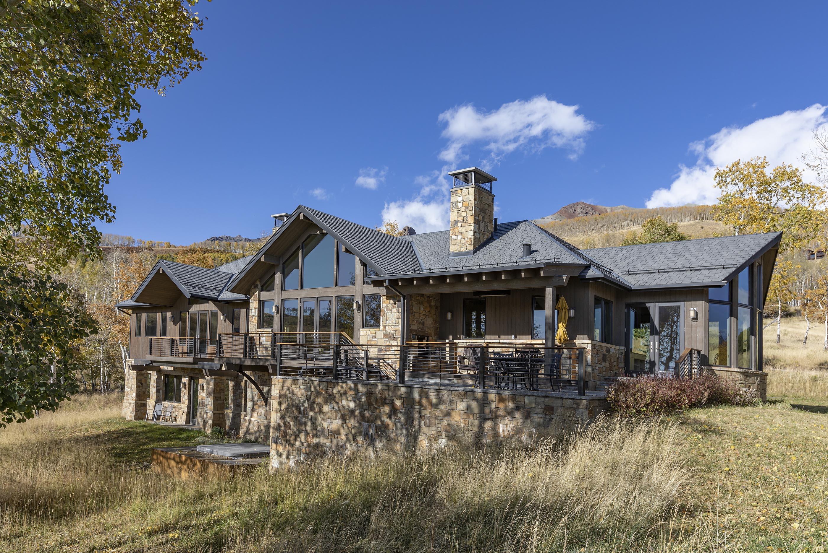 107 Miguel Road Telluride, CO 81435 - Photo 2 of 32 a front view of a house with a fountain