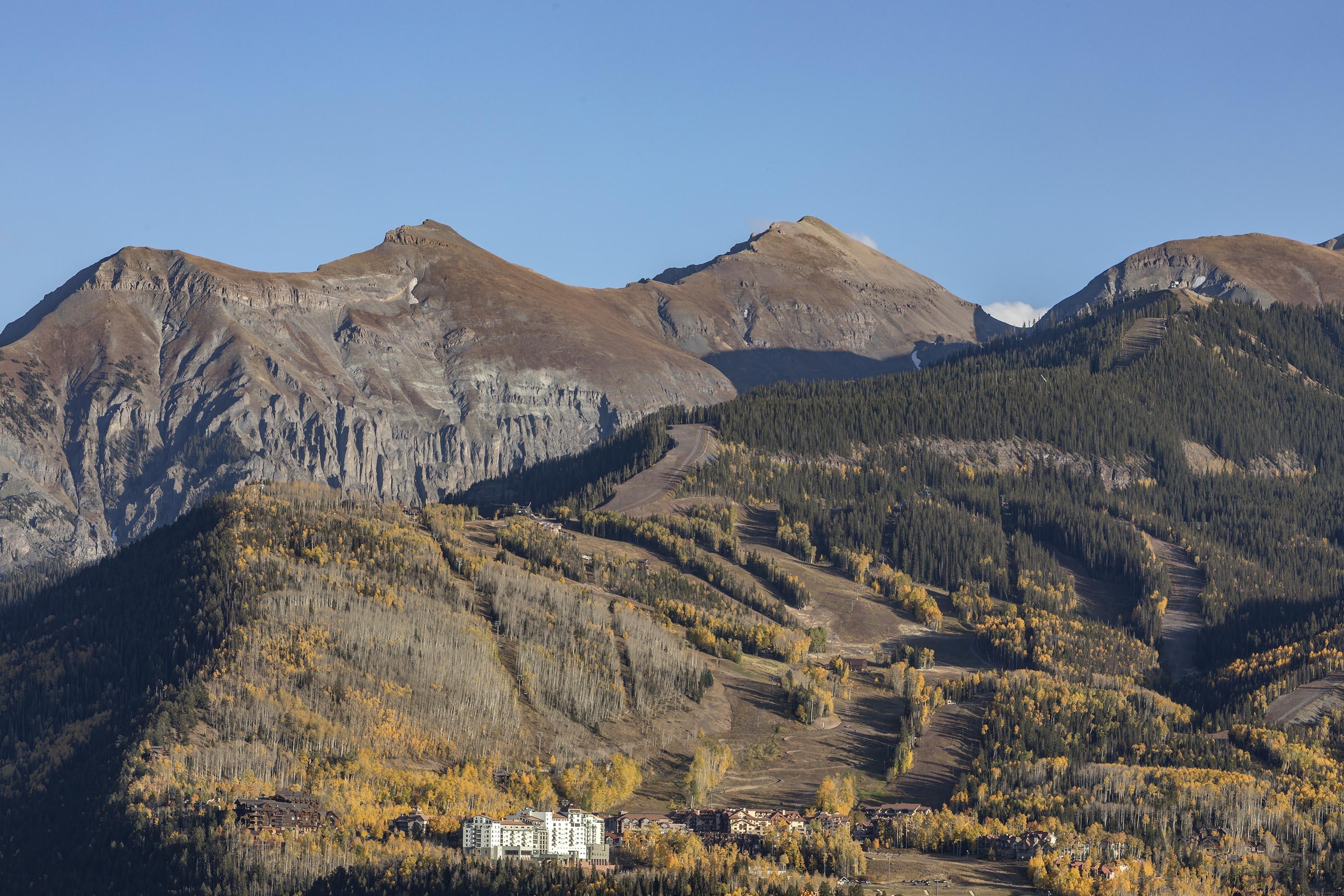 107 Miguel Road Telluride, CO 81435 - Photo 32 of 32 a view of a large building with a mountain in the background