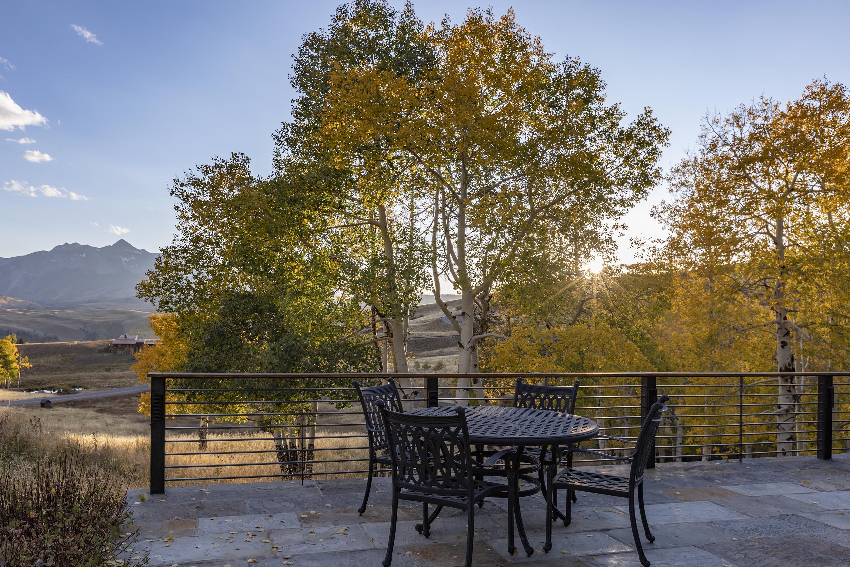 107 Miguel Road Telluride, CO 81435 - Photo 4 of 32 a view of a roof deck with table and chairs with wooden floor and fence