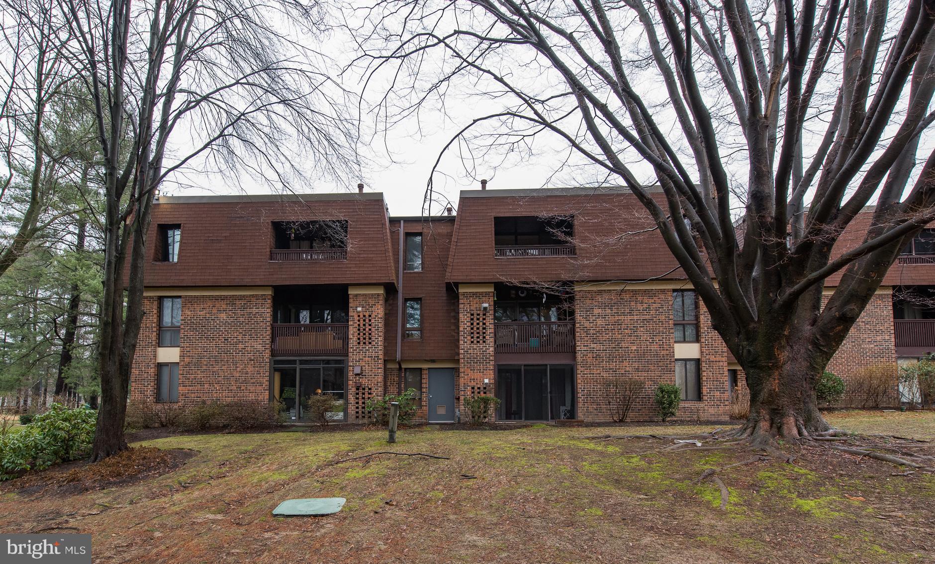 5232 West Running Brook Road, Unit 301 Columbia, MD 21044 - Photo 1 of 29 a brick building that has a tree in front of it