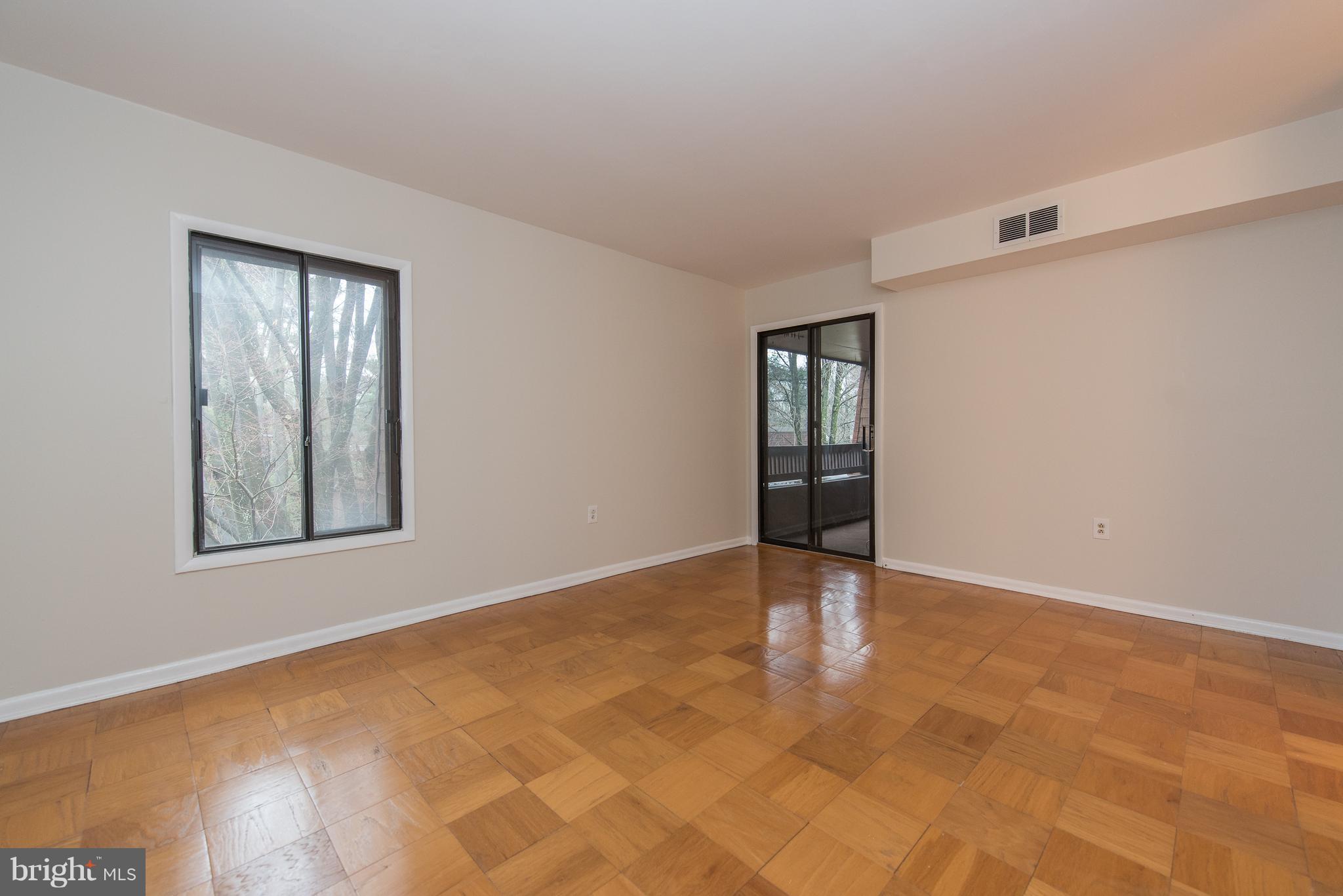 5232 West Running Brook Road, Unit 301 Columbia, MD 21044 - Photo 20 of 29 a view of an empty room with window and wooden floor