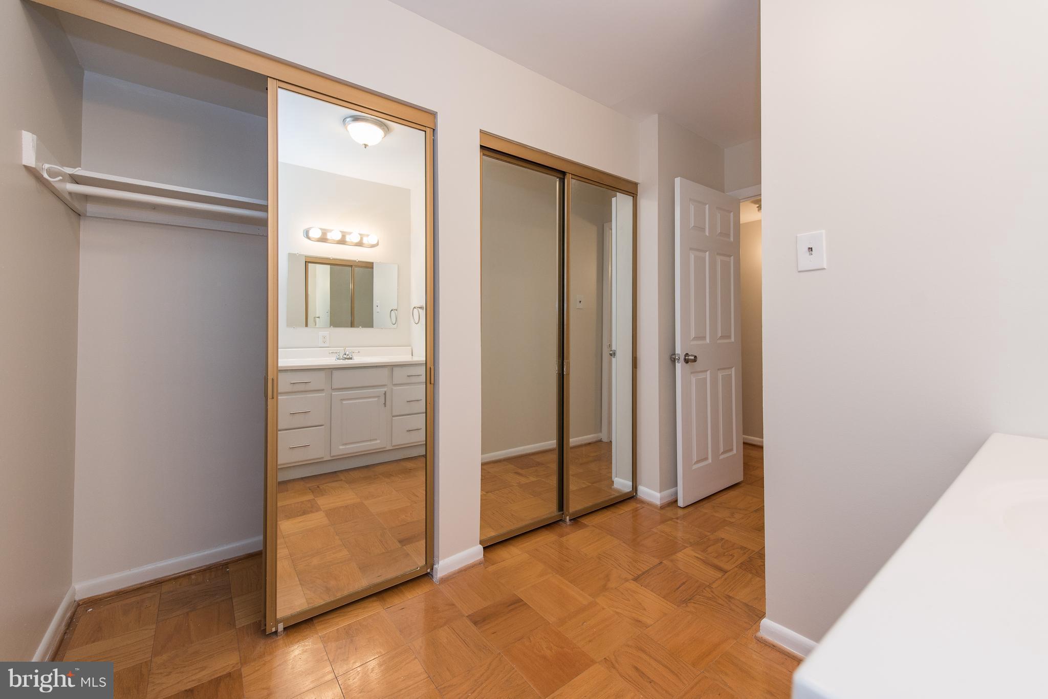 5232 West Running Brook Road, Unit 301 Columbia, MD 21044 - Photo 27 of 29 an empty room with wooden floor and entrance
