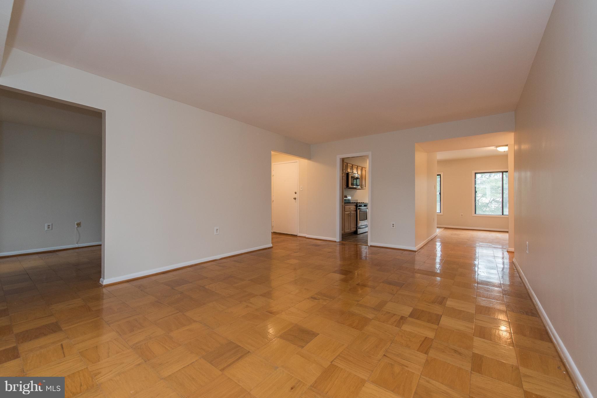 5232 West Running Brook Road, Unit 301 Columbia, MD 21044 - Photo 5 of 29 a view of an empty room with window and wooden floor