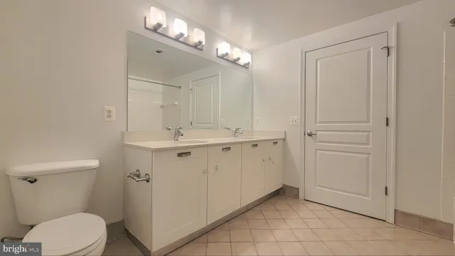 a bathroom with a sink a toilet and mirror