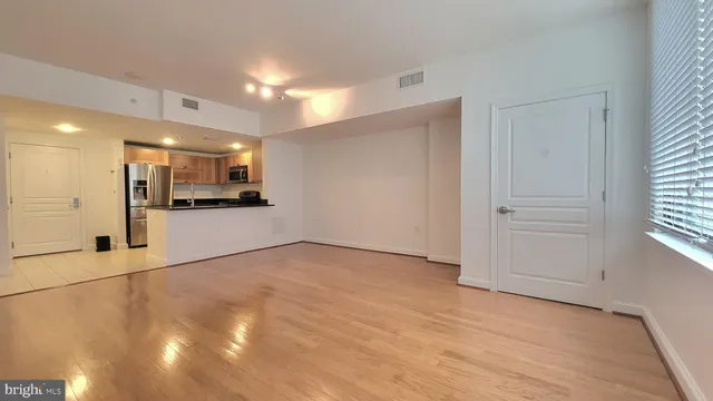 a view of a kitchen with a sink and a refrigerator