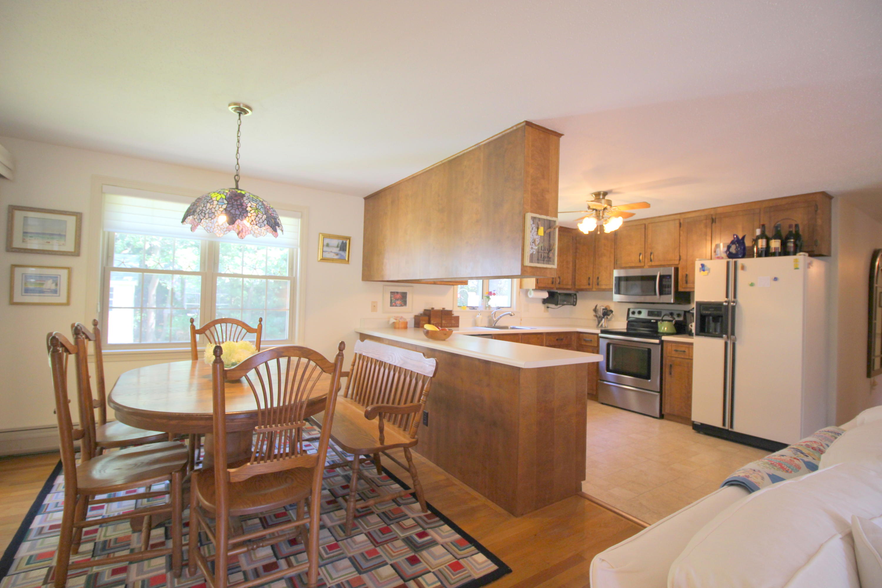 10 Micah Hamlin Road Centerville, MA 02632 - Photo 8 of 35 a kitchen with a dining table chairs and refrigerator