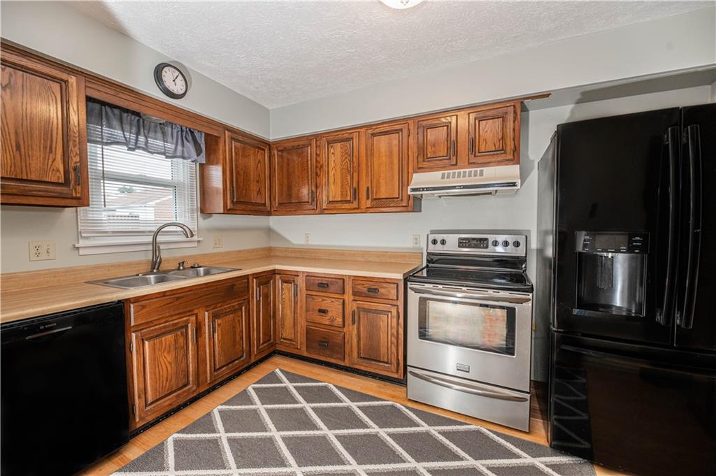 149 Canterbury Commons Indiana, PA 15701 - Photo 4 of 9 a kitchen with a sink stove and refrigerator