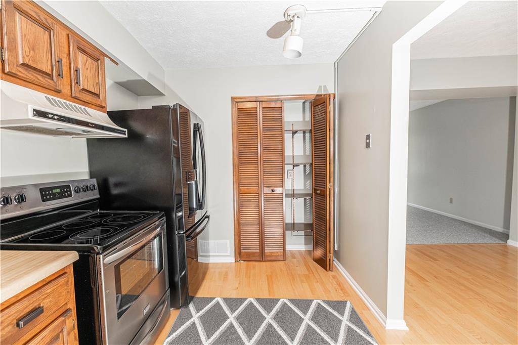 149 Canterbury Commons Indiana, PA 15701 - Photo 5 of 9 a kitchen that has a stove and a refrigerator