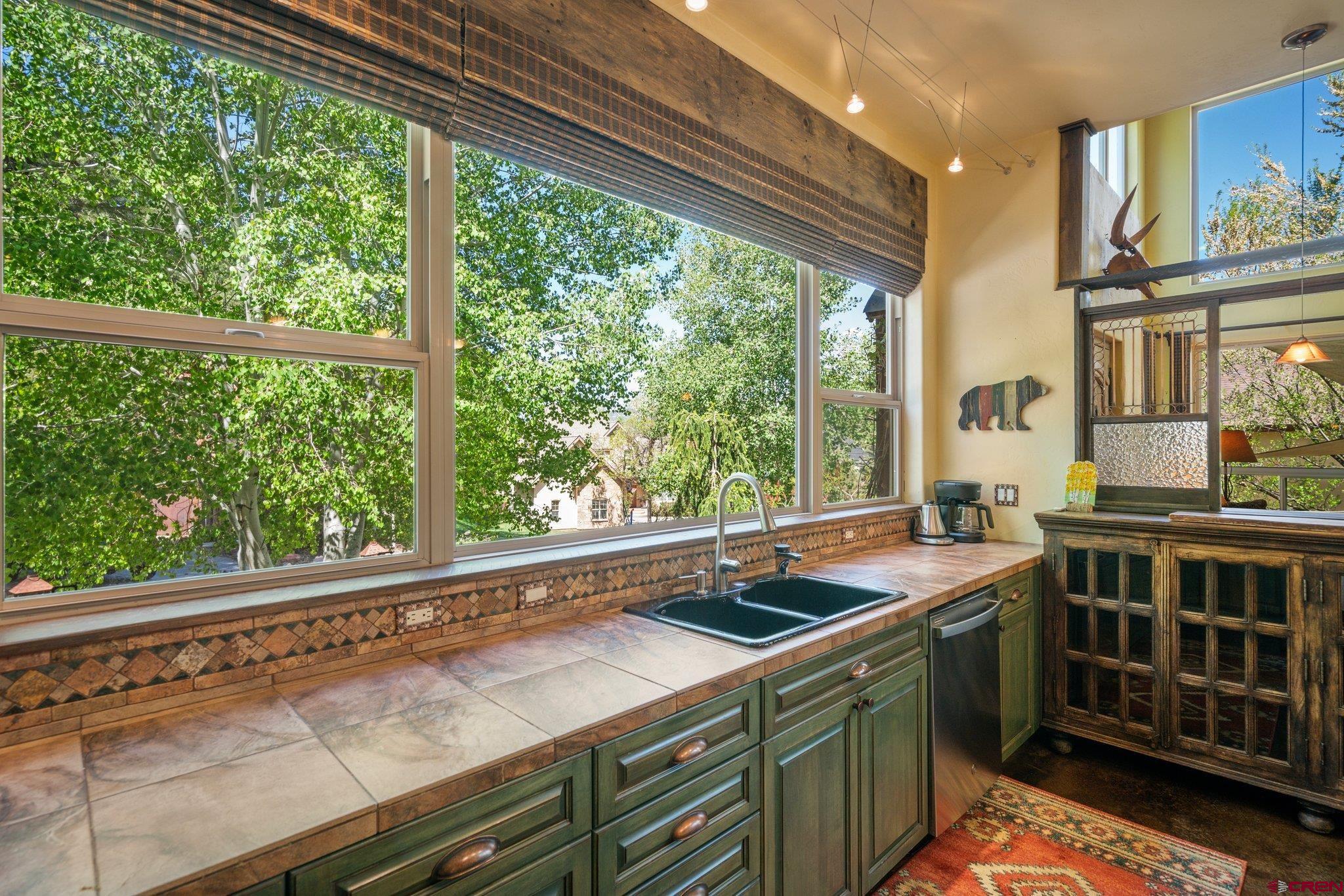 145 Ute Pass W Road Durango, CO 81301 - Photo 10 of 35 a kitchen that has a sink and a wooden floor