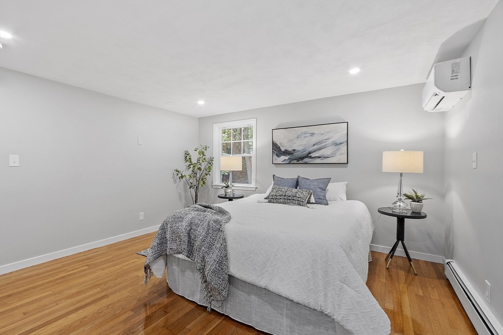 167 Harvard Road Stow, MA 01775 - Photo 16 of 27 a bedroom with a bed and wooden floor