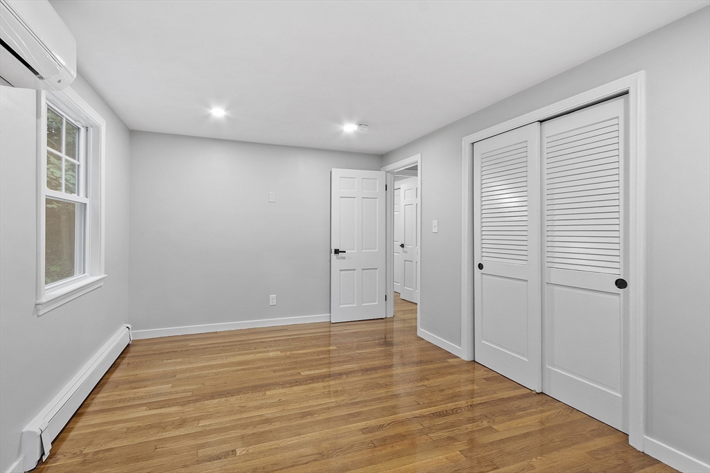 167 Harvard Road Stow, MA 01775 - Photo 21 of 27 a view of an empty room with wooden floor and a window